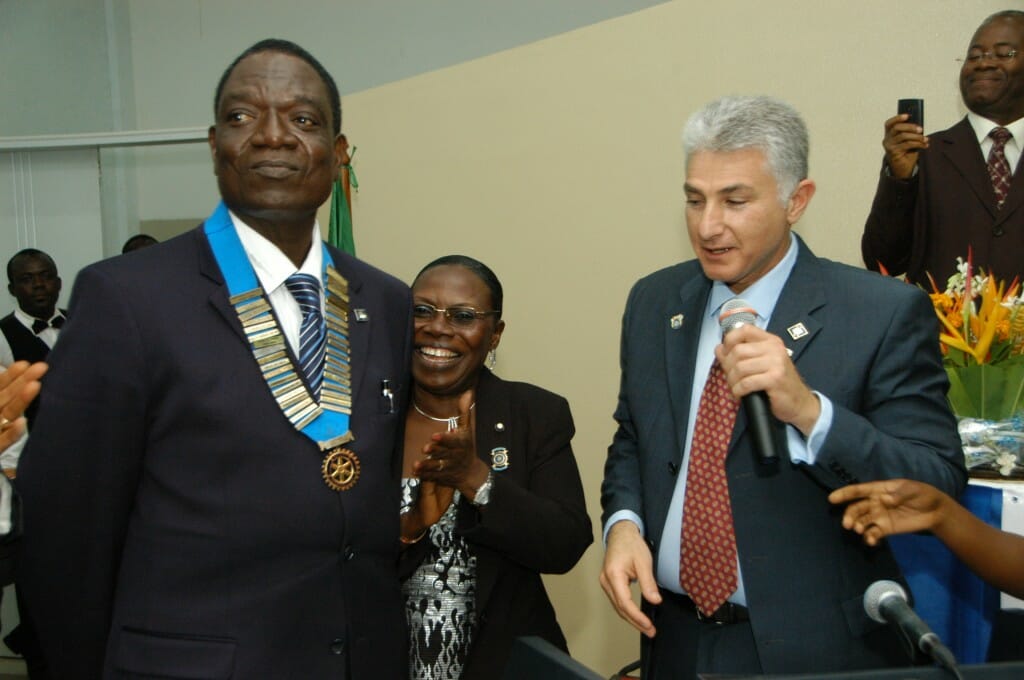 Newly-installed District 9100 governor, Bouraima Salifou, left, flanked by out-going governor Marwan Fattal and wife Fahimatou Aline Salifou, savors the moment.
