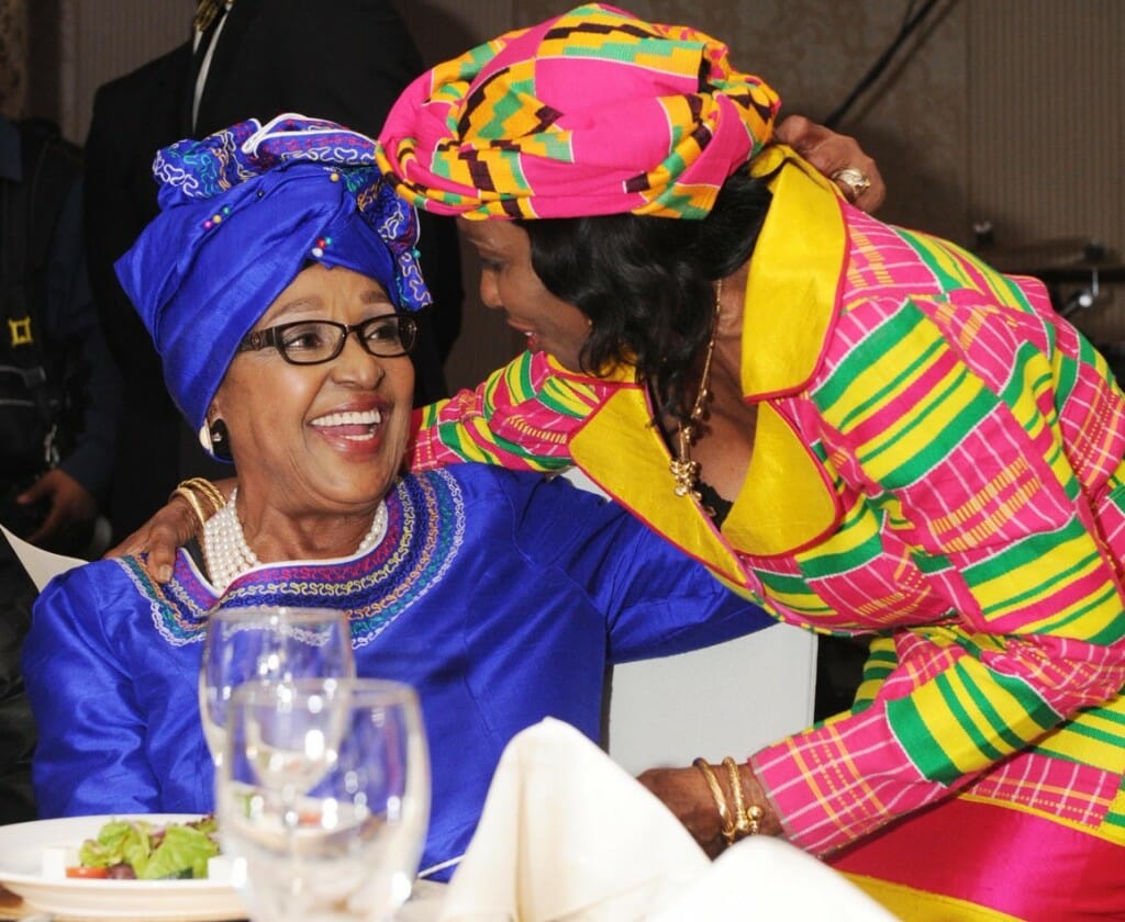 Warm embrace between anti-apartheid heroin Winnie Madikizela-Mandela (seated) and former Ghanaian first lady, Nana Konadu Agyeman Rawlings.