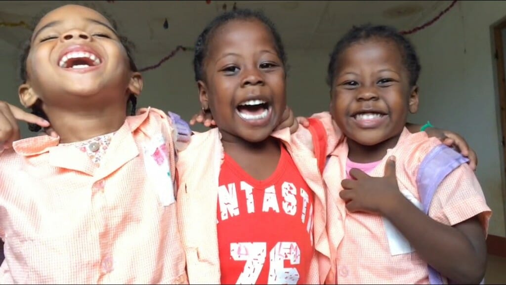 Cute as a cucumber, Melody, left, and the two thirds of the triplets shouting 'I love Tatty Cherish,’ the only English sentence the children mastered while Cherish Chirume volunteered at La Maison.