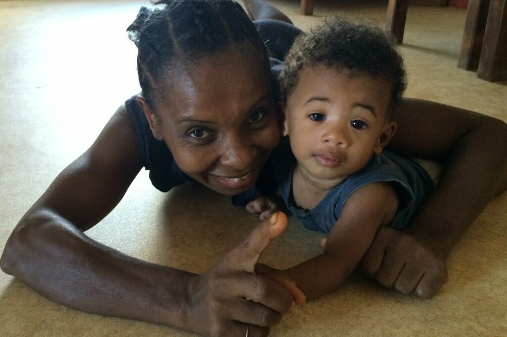 Tatty Lantu (the children’s nanny) trying to get adorable Chancelloh to look at the camera but he was finding her face more edible!