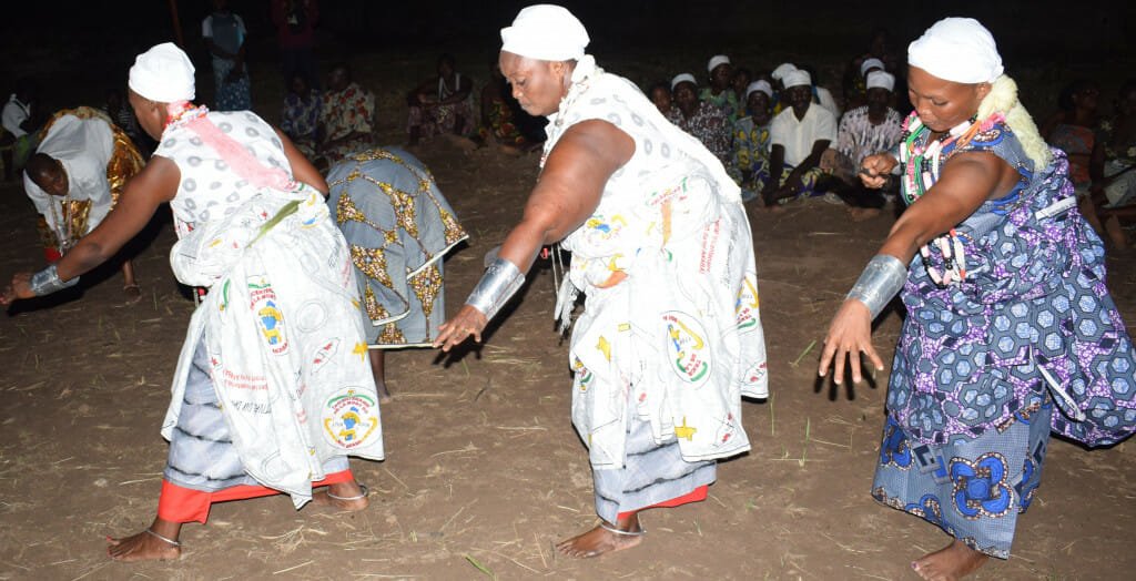 Three of the half-dozen women embodying the late kings of Danxomê perform a special dance for King Aïhotogbé of Cana