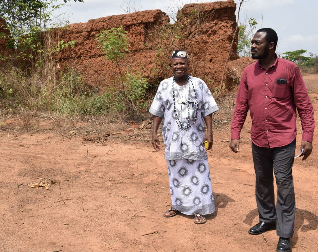From left to right: Dah Wankpo, a dignitary of the Cana royal court, and The African's founder and publisher, Soumanou Salifou, visit the ruins of the royal palace that served as King Gbêhanzin's army headquarters during the last phase of his resistance to colonization. The palace, built by his father, King Glèlè, was set ablaze by the French army, and no fewer than 4,000 female warriors, the amazons, perished here in mano-a-mano combat in 1894.