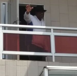 Former President Yayi Boni waves at the crowd from his balcony