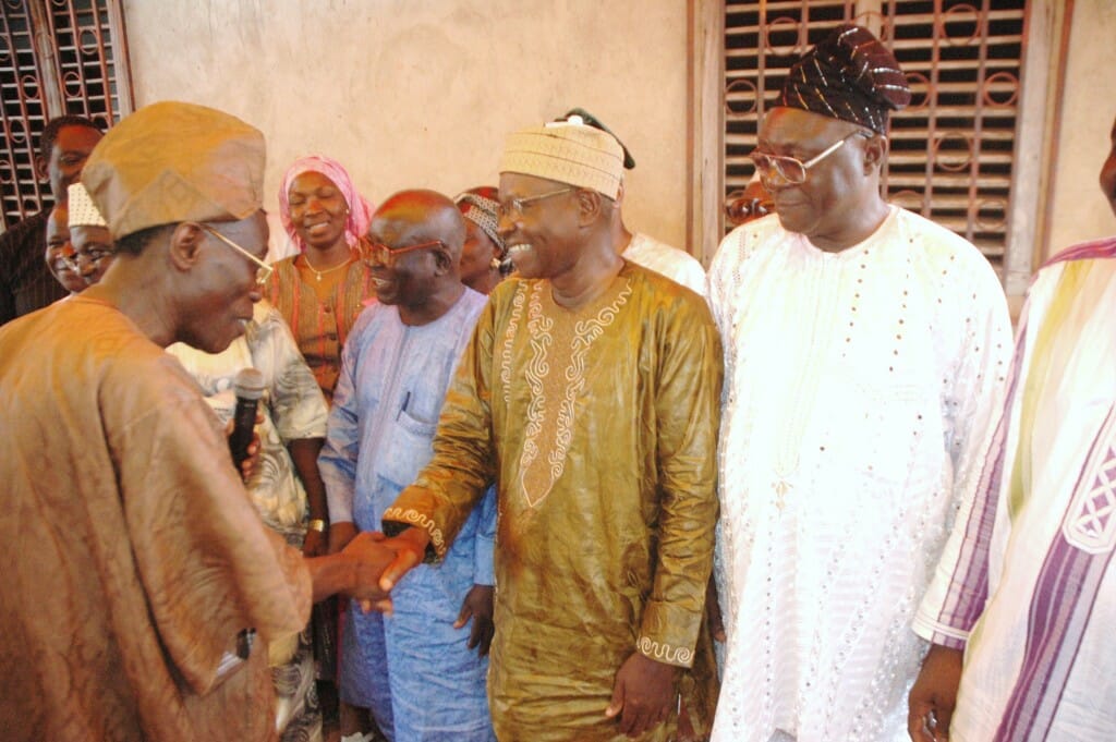 Al-Hadji Mouftaou Alidou shakes hands with younger Salifou family members upon his arrival in the family's home in Cana in 2010 for their annual family reunion.