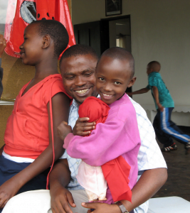 Peter Mmassy with one of the happy children. 