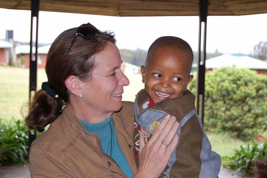 India Howell holding one of her 97 adopted children