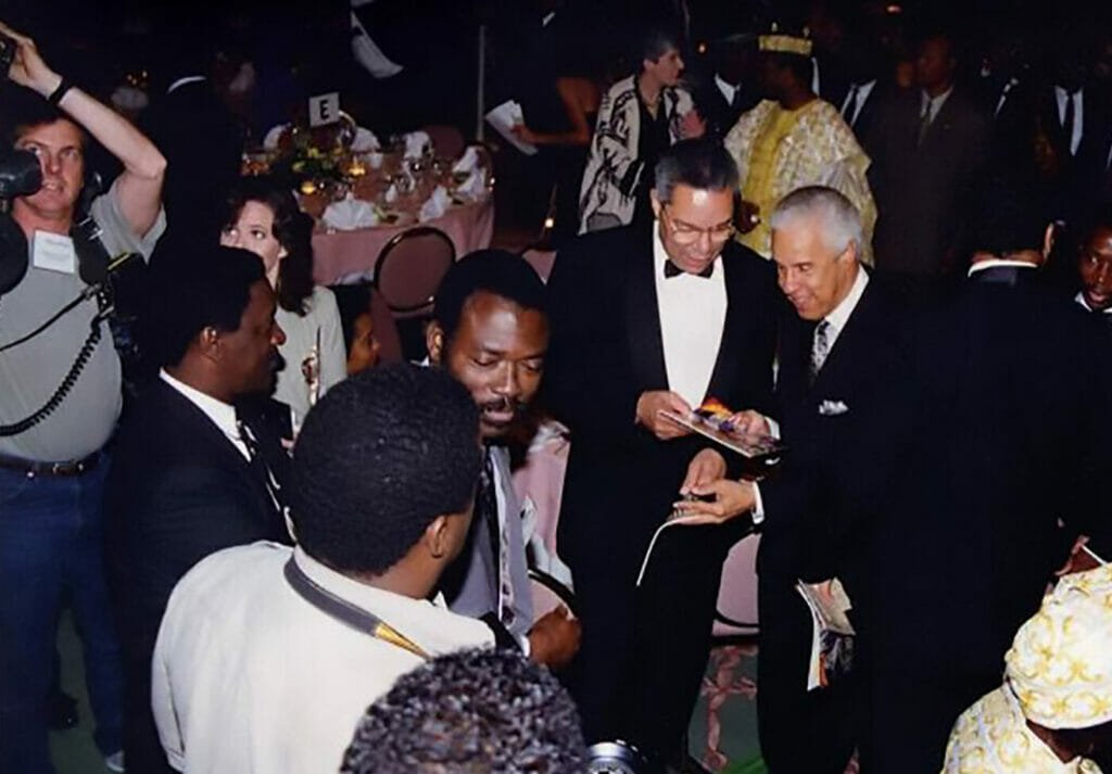 This image shot on October 6, 1994 at the Sheraton Hotel in Washington, D.C. during the grand launch of The African magazine shows the late Gen. Colin Powell newly retired from his position as the chairman of the Joints Chief of Staff, and former Virginia Governor Doug Wilder glancing through the maiden issue of the magazine while the Rev. Jesse Jackson has his back turned to the camera. 