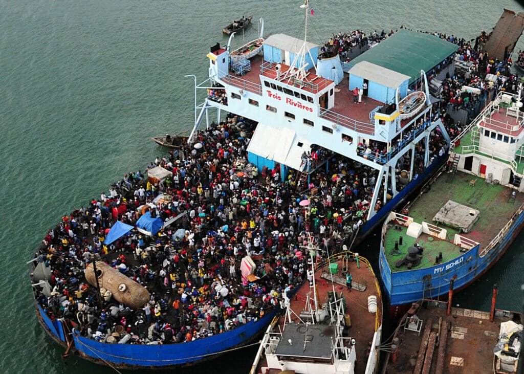 100116-N-6247V-143 PORT-AU-PRINCE, Haiti (Jan. 16, 2010) Haitian citizens crowd a ship near a port in Haiti Jan. 16, after earthquake devastation left many homeless, injured and hungry. The aircraft carrier USS Carl Vinson (CVN 70) and Carrier Air Wing (CVW) 17 are conducting humanitarian and disaster relief operations as part of Operation Unified Response after a 7.0 magnitude earthquake caused severe damage Jan. 12, 2010. (U.S. Navy photo by Mass Communication Specialist 2nd Class Candice Villarreal/Released)