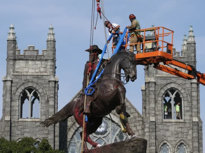 Crews attach straps in July to the statue of Confederate Gen. J.E.B. Stuart in Richmond, Va.
