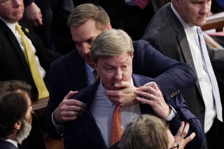 Rep. Richard Hudson, R-N.C., pulls back Mike Rogers, R-Ala, to avoid a possible fist fight with Rep. Matt Gaetz, R-Fla, during the elecgtion of the Speaker