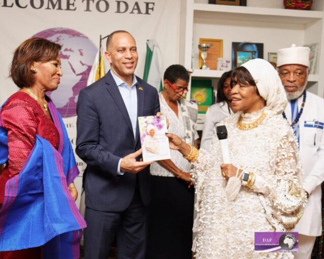 Ambassador Erieka Bennett, Founder and Head of Mission of the Diaspora African Forum, presents her book, “Just Be Aging Gracefully,” to Congressman Hakeem Jeffries.