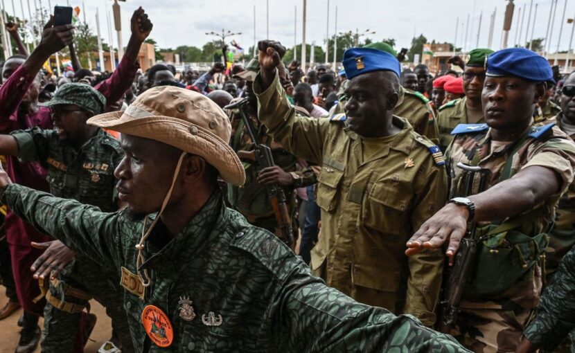 Niger's National Council for the Safeguard of the Homeland Colonel-Major Amadou Abdramane, second from right, is greeted by supporters upon his arrival at the Stade General Seyni Kountche in Niamey on August 6, 2023. AFP/Getty Images 
