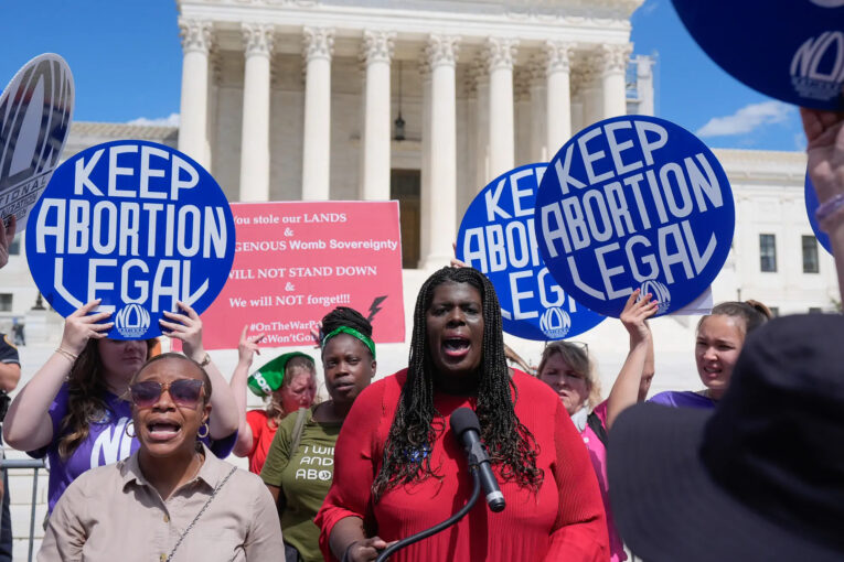 Led by NOW President, Christian Nunes, a group of women holds a pro-reproductive rights rally in front of the U.S. Supreme Court.