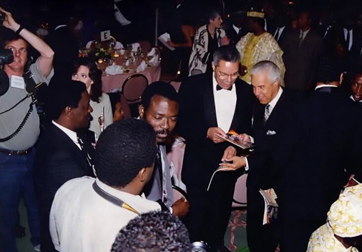 Coming to life on October 6, 1994, the day AFRICARE, the largest African American organization that provides development aid to Africa, honored then-South African President Nelson Mandela, The African Magazine was introduced to this large crowd of distinguished African and American Leaders. Standing a few steps away from former Chairman of the Joint Chiefs of Statf, former VA Governor Doug Wilder and the Rev. Jesse Jackson, Founder/Publisher Soumanou is overwhelmed with emotion, with his eyes closed. Image by Damien Padonou.