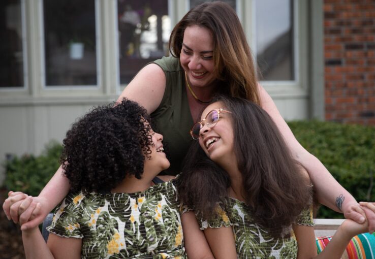 Mother and daughters sharing a joyful moment