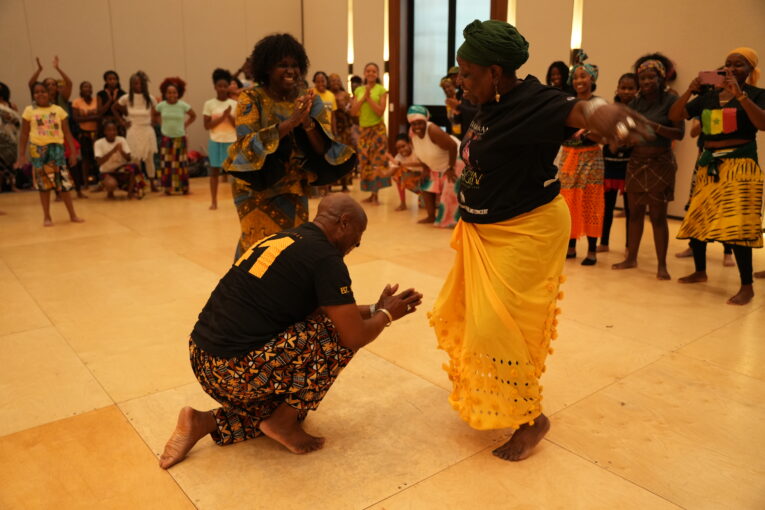 Co-founder, artistic director and senior dancer Papa Assane congratulating one of the student-dancers during one of the company's classes.