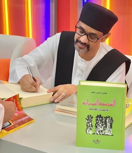 The author autographs a book for a reader