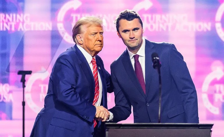 The late Charlie Kirk, right, shakes hands with Donald Trump